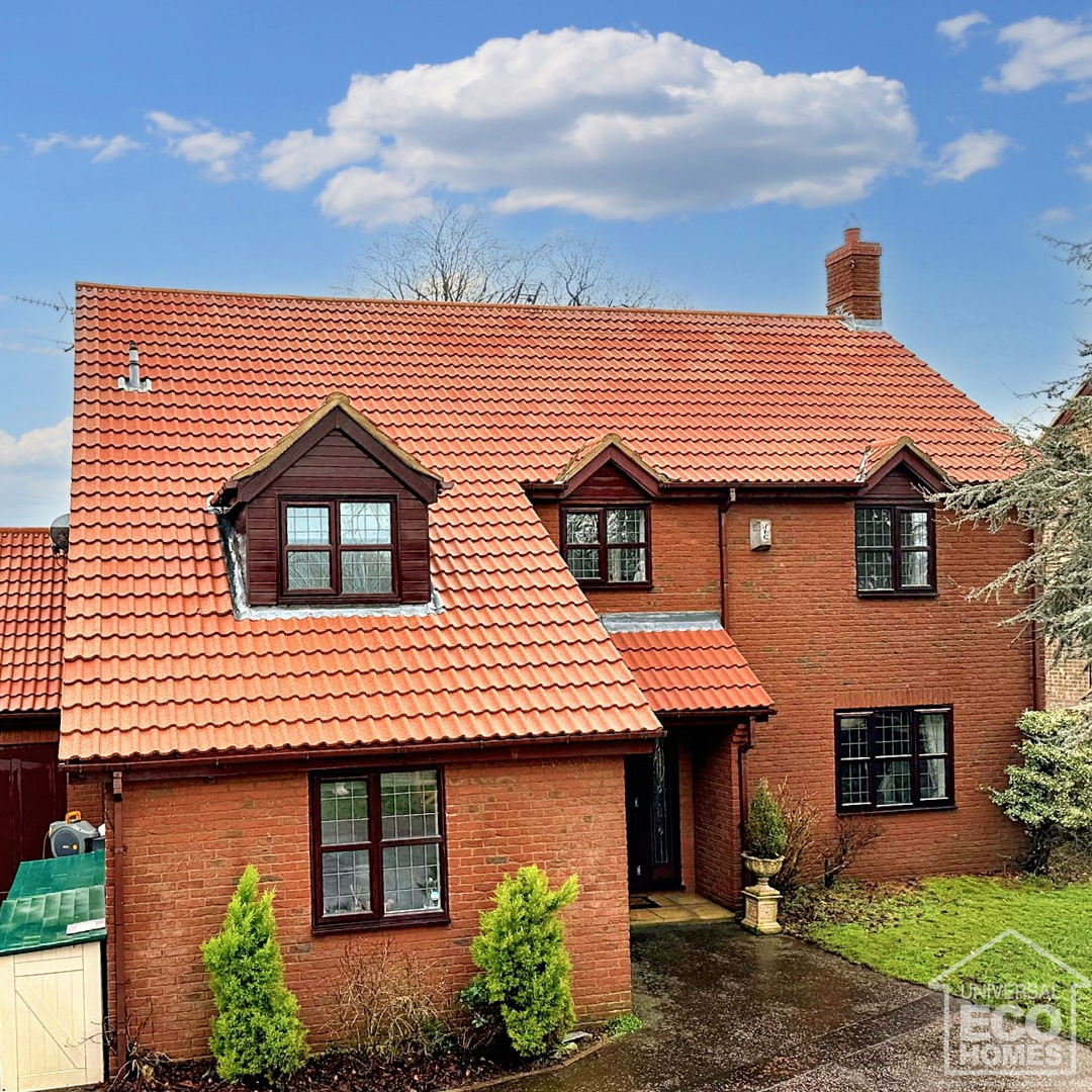 Detached home after roof cleaners have cleaned and coated roof