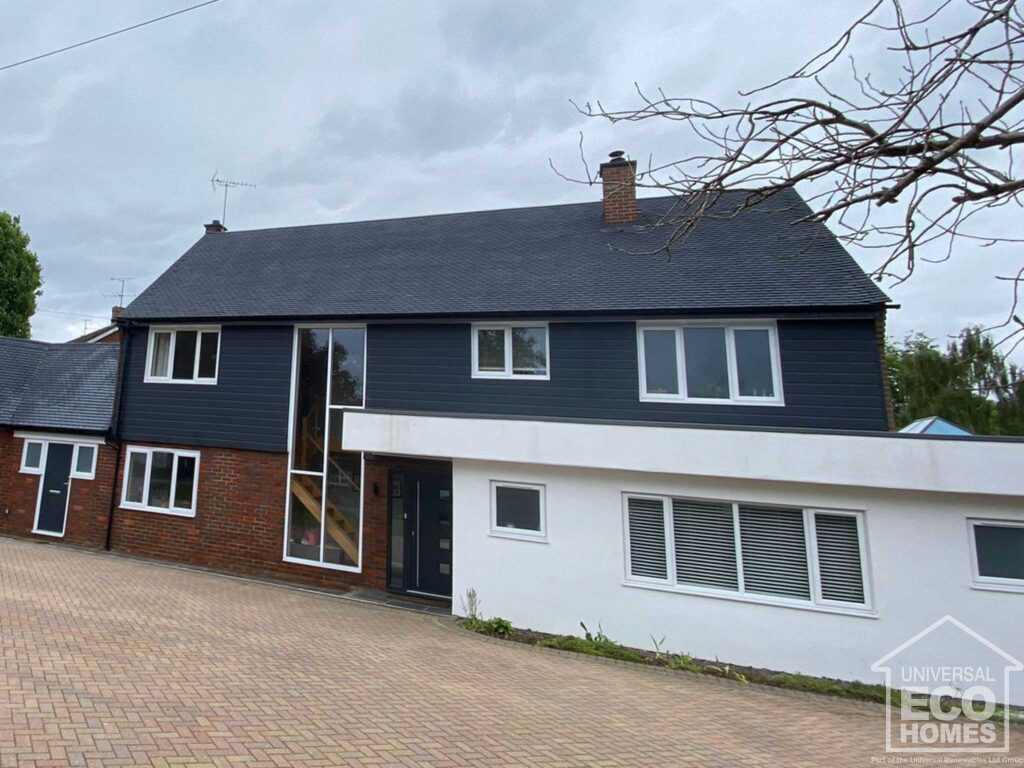 Exterior of large home after properla roof coating by Universal Eco Homes