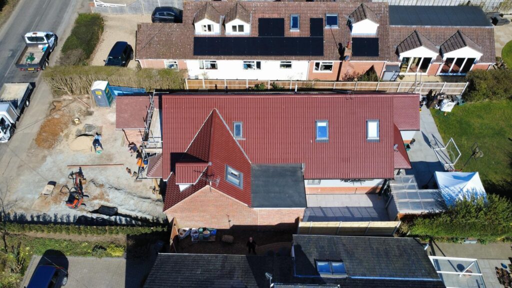 red roof coating on a house after roof coating companies visit
