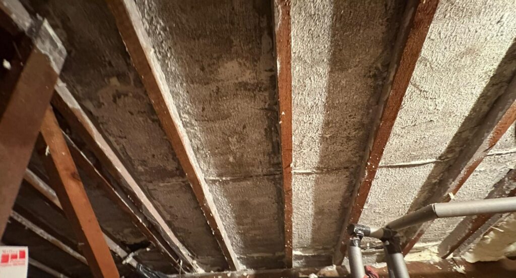 Before and after images showing professional spray foam insulation removal in a residential loft space.