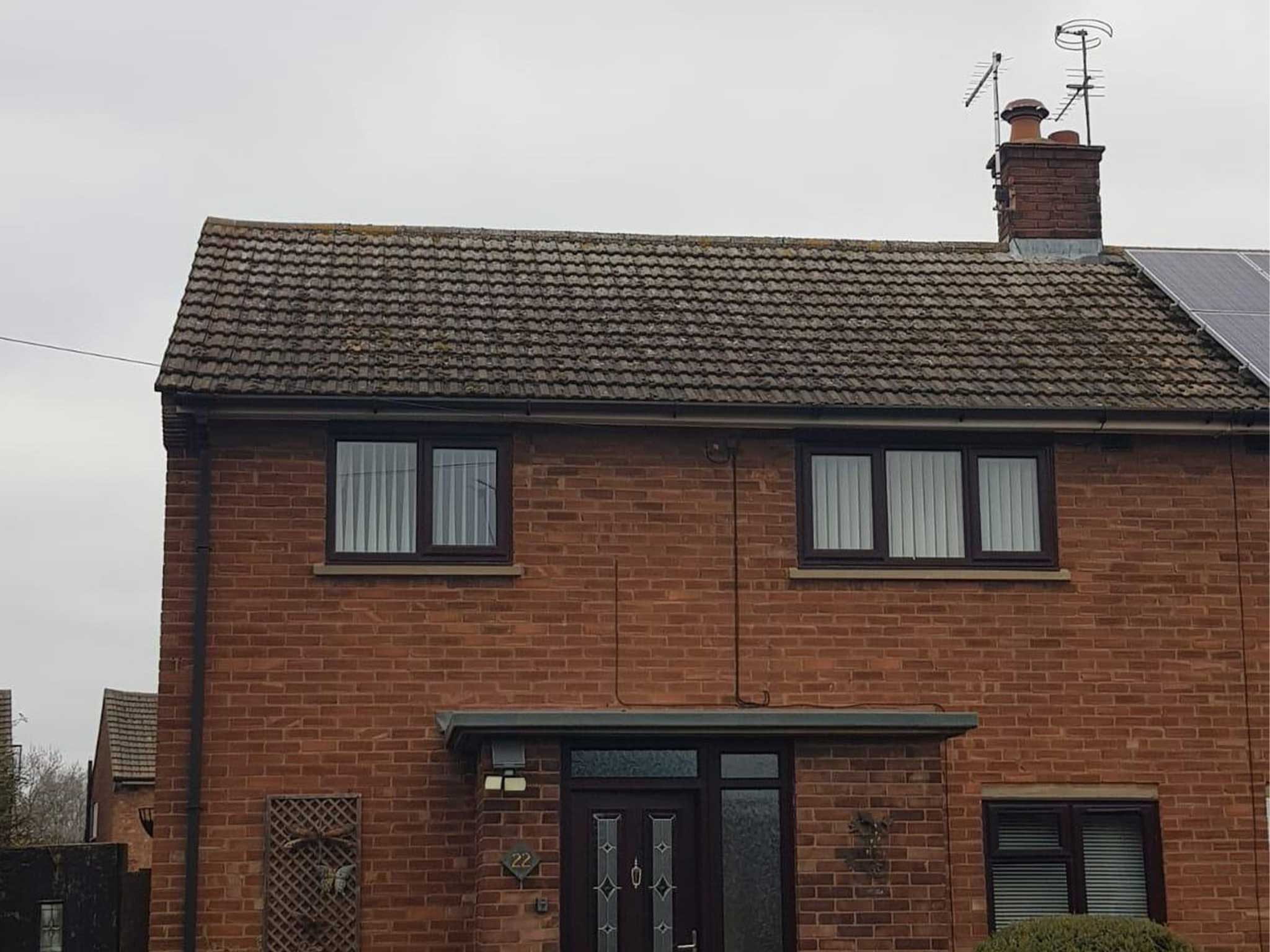 Exterior of front of brick semi detached house before moss removal and roof cleaning by Universal Eco Homes