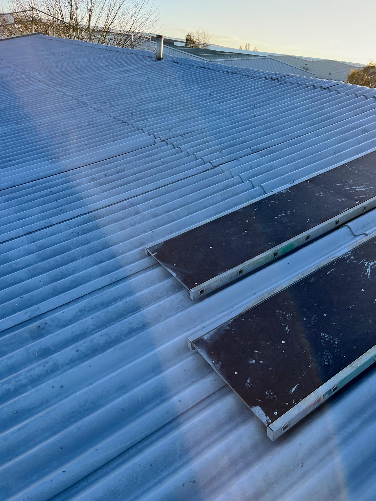 Exterior shot of revitalised metal sheeted roof after asbestos roof cleaning by Universal Eco Homes