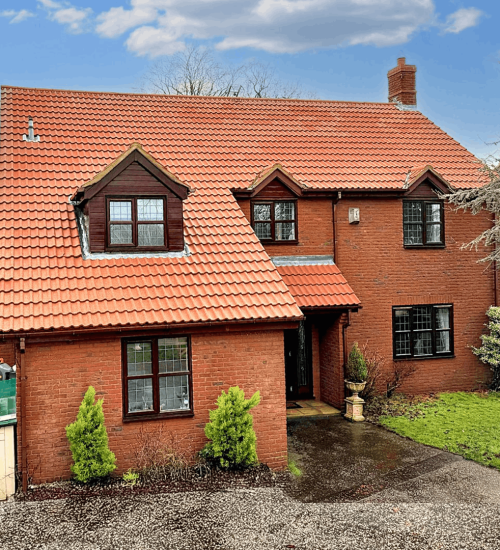 Exterior of beautiful detached home after moss removal and roof cleaningby Universal Eco Homes