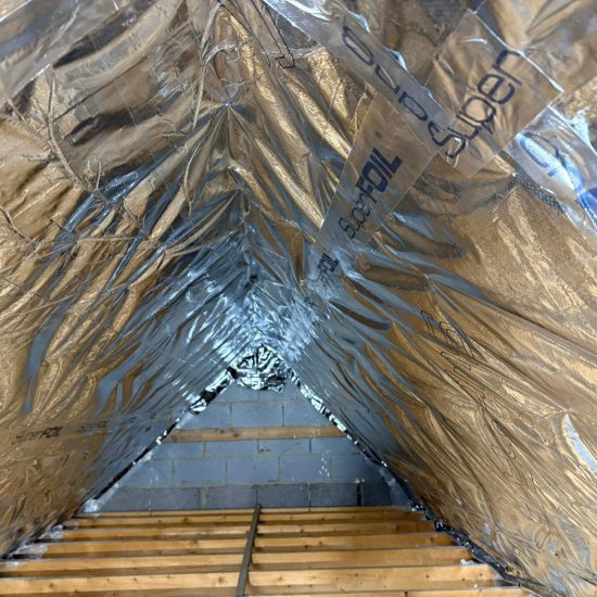 Loft Insulation vs Spray Foam Removal: UK loft insulated with modern foil-based insulation as a safe alternative to spray foam