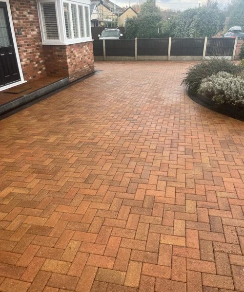 Before and after results of a professional driveway cleaning service removing moss and grime.