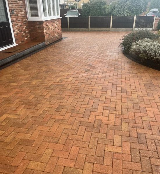 Before and after results of a professional driveway cleaning service removing moss and grime.